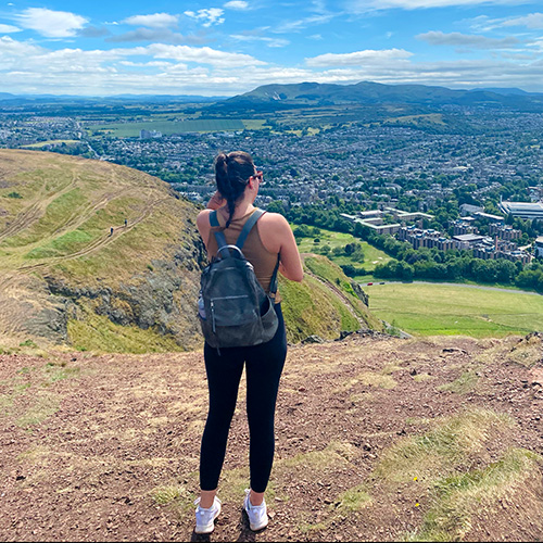 Mel looking down over a mountain valley