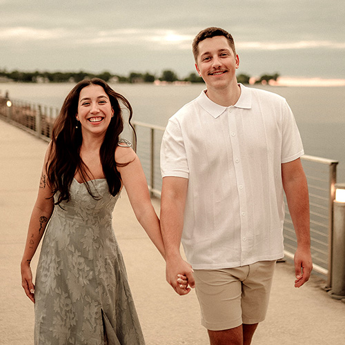 Mel holding hands with fiancé