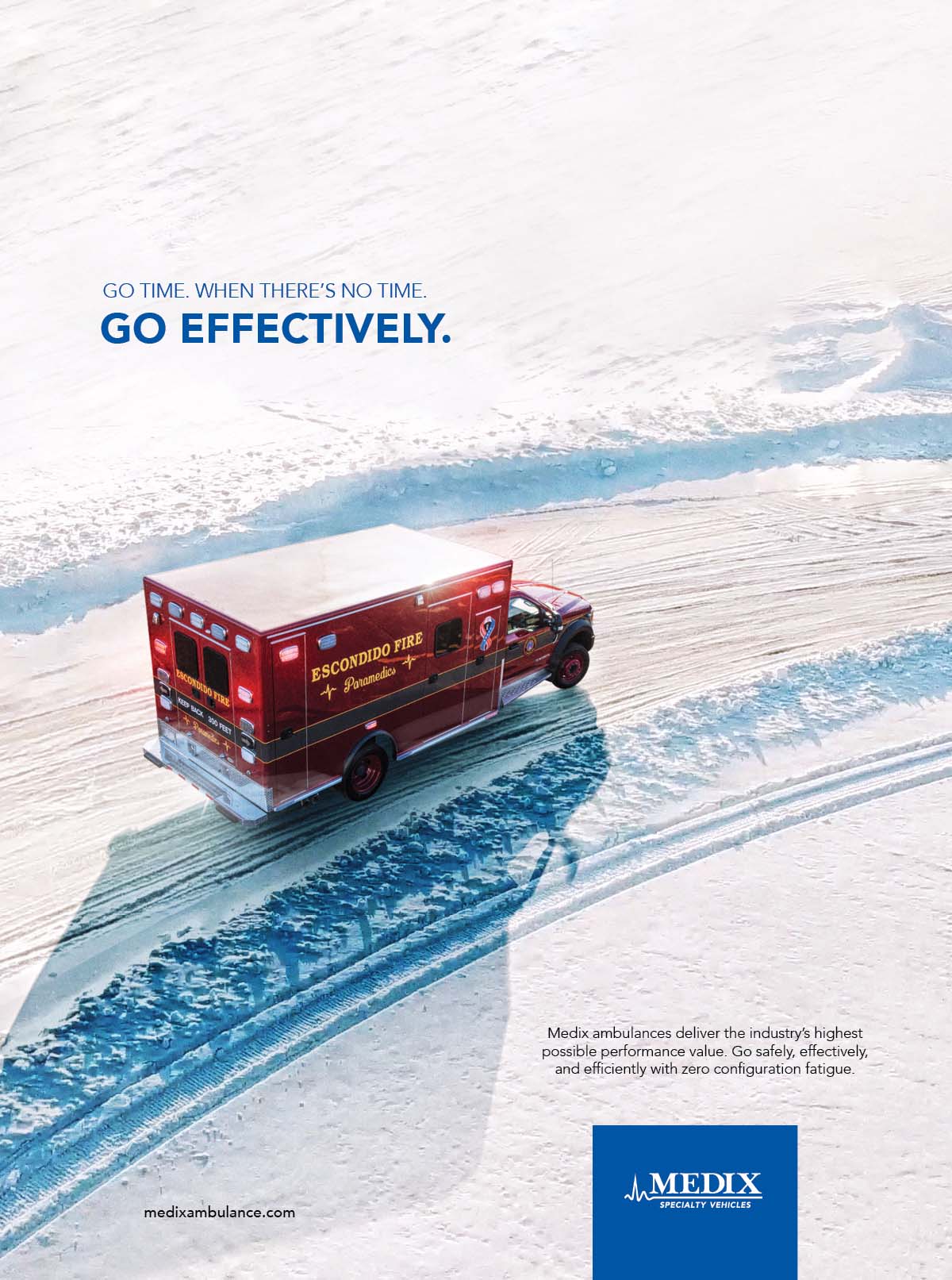 A red Medix ambulance drives around a turn on a snow covered road in the winter