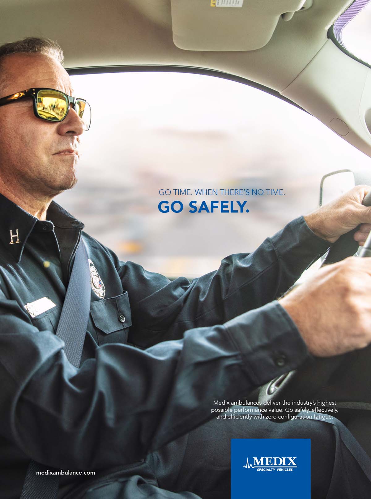 A close up photo of a Medix Ambulance driver wearing a seat belt, EMS uniform and sunglasses