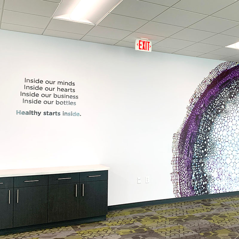 Nature's Way interior wall with a graphic of a cross-section of a cell and branding-affirming lettering
